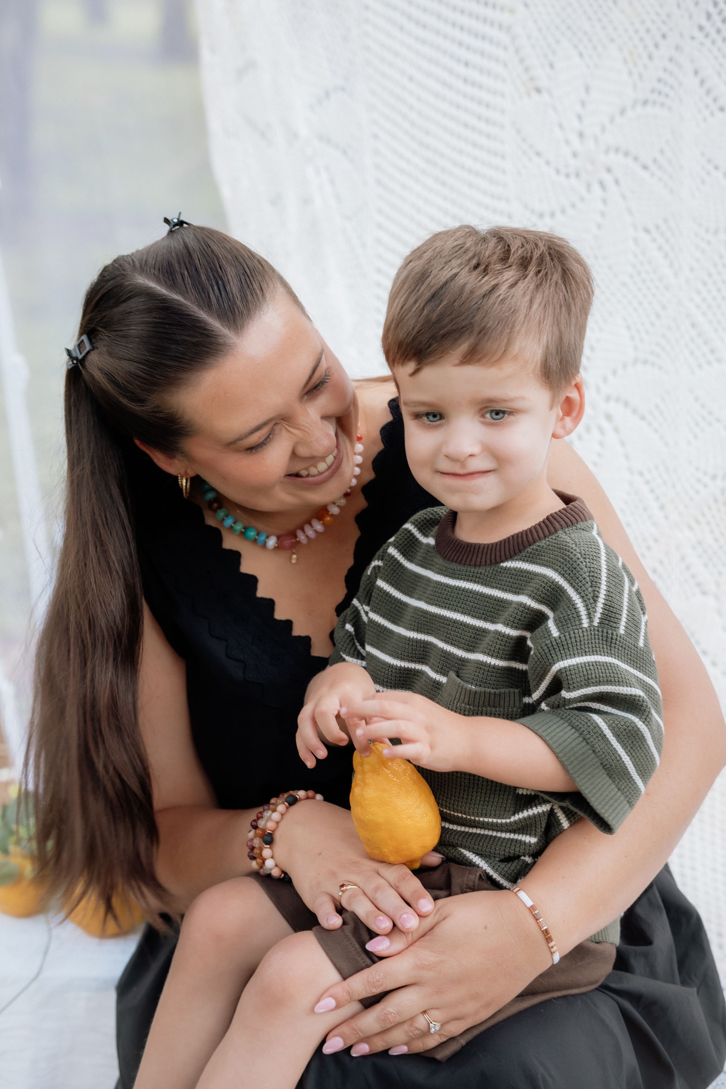 A tender moment captured in black and white as a parent and child share affectionate interactions and laughter.