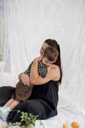 Intimate family portrait session with white lace backdrop and citrus decor.