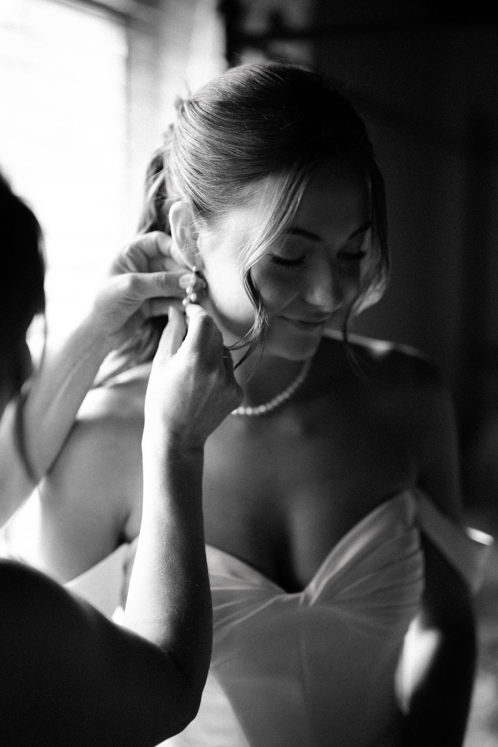 A sequence of black and white photos showing a bride getting ready on her wedding day, captured in candid moments.