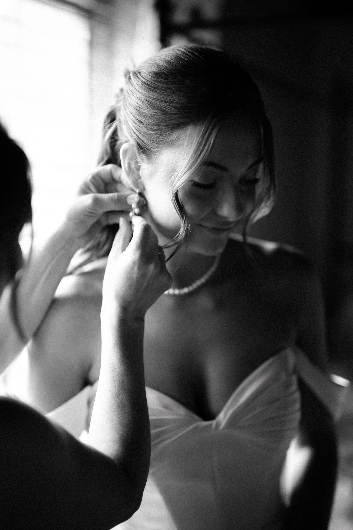 A sequence of black and white photos showing a bride getting ready on her wedding day, captured in candid moments.