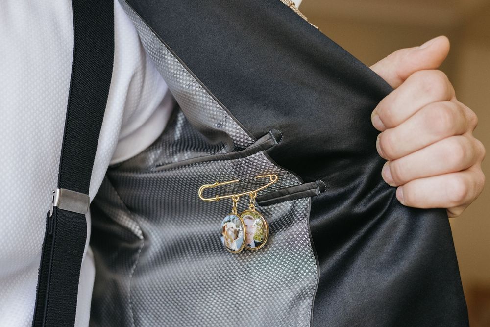 Close-up detail of a light blue bridesmaid dress being adjusted with delicate hand movements.