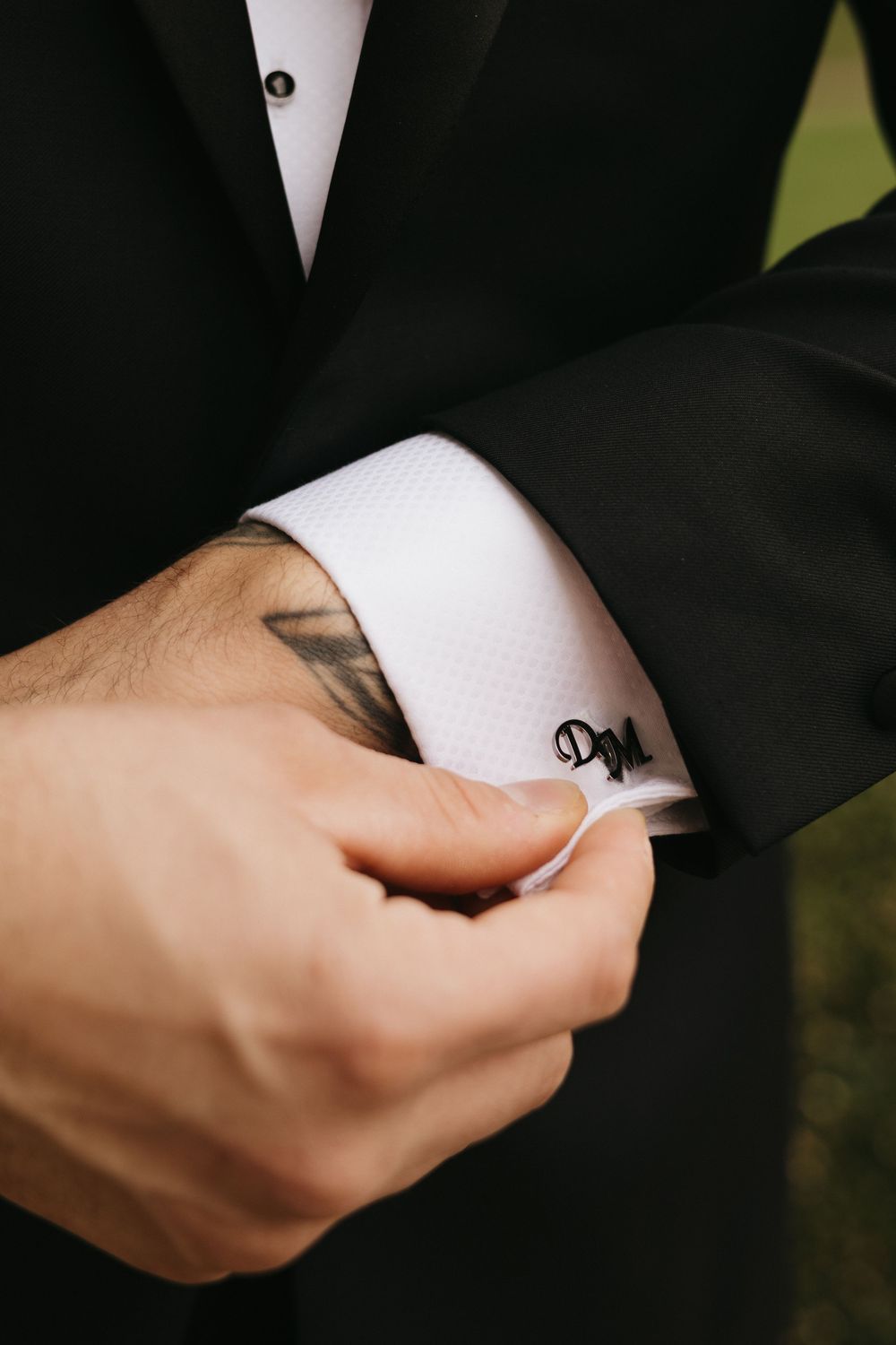 Detail shots of hands in formal wedding attire against a dark background.