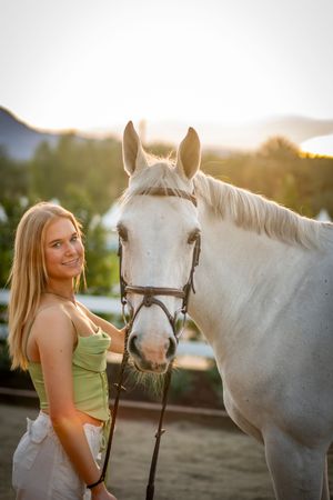 White horse and companion enjoy sunset photoshoot.