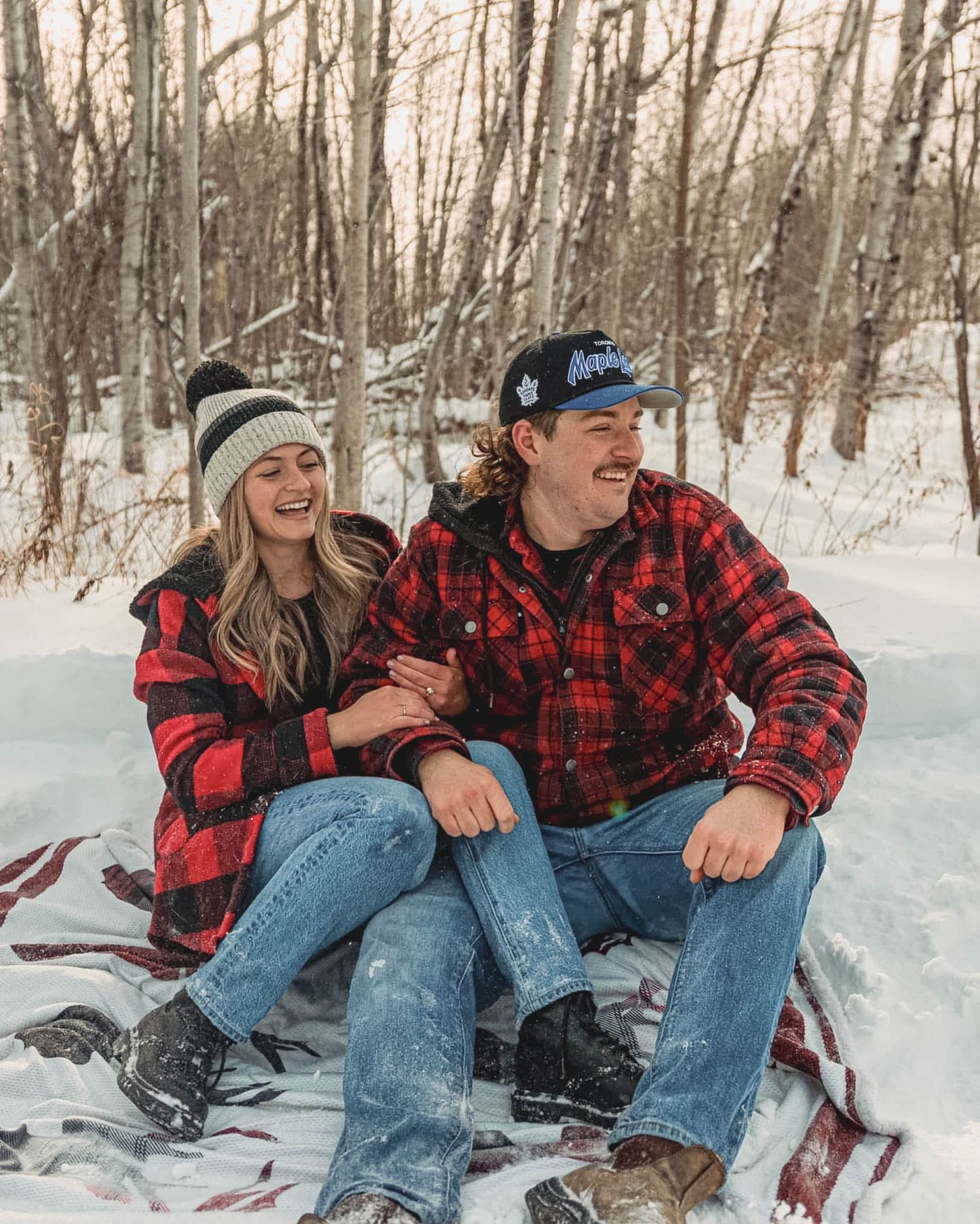 couple in snow with dog