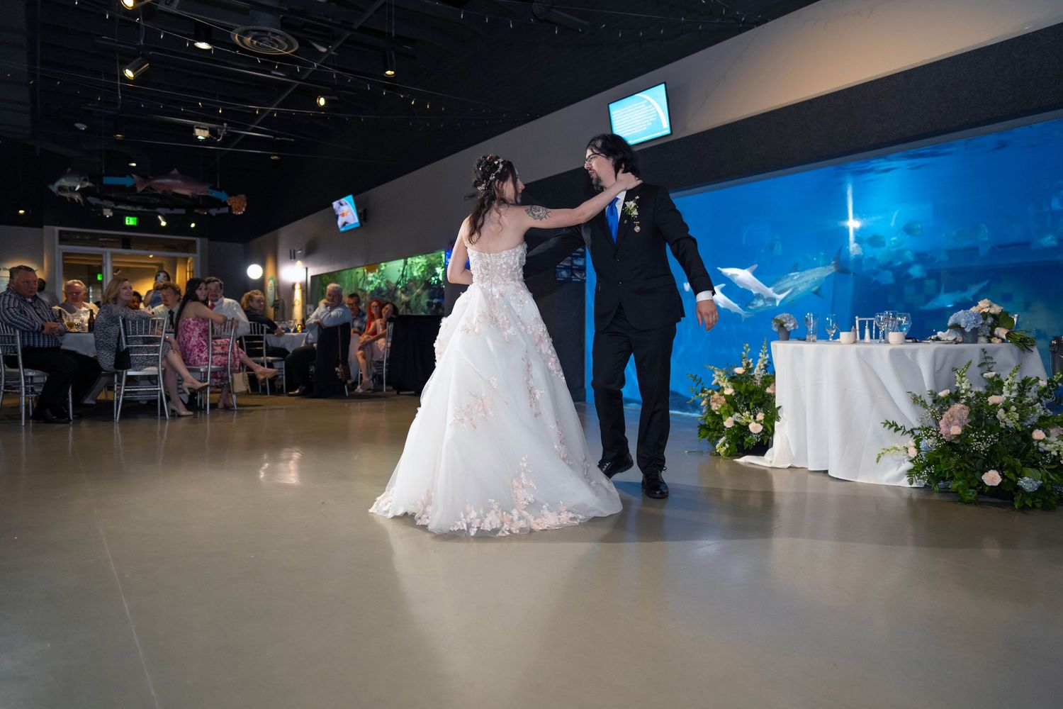Bride and groom share their first dance at an elegant aquarium wedding venue Toledo Zoo Wedding Venue