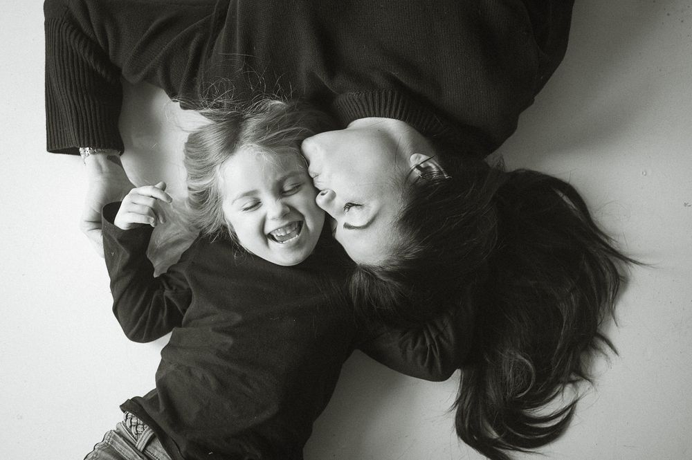 A series of intimate black and white photos showing tender moments in soft lighting.