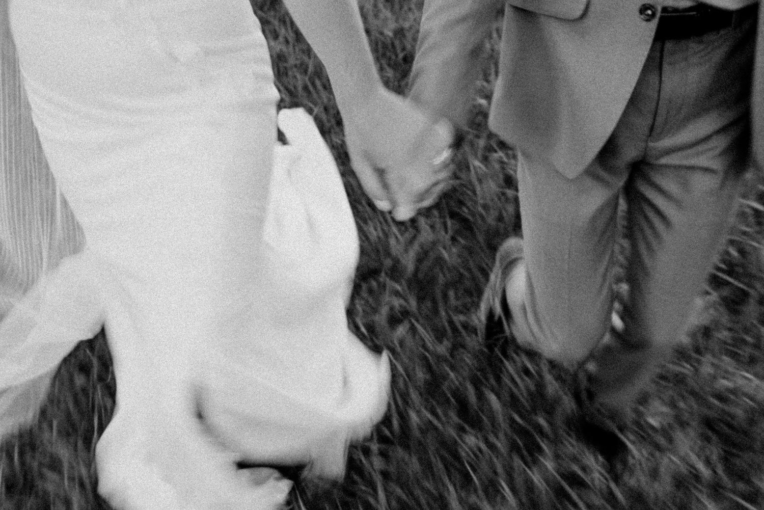 A romantic couple embraces in a series of candid black and white wedding photos.
