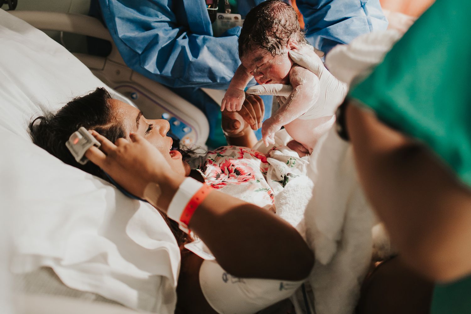 Medical team performs surgery in operating room with green scrubs and bright lighting.