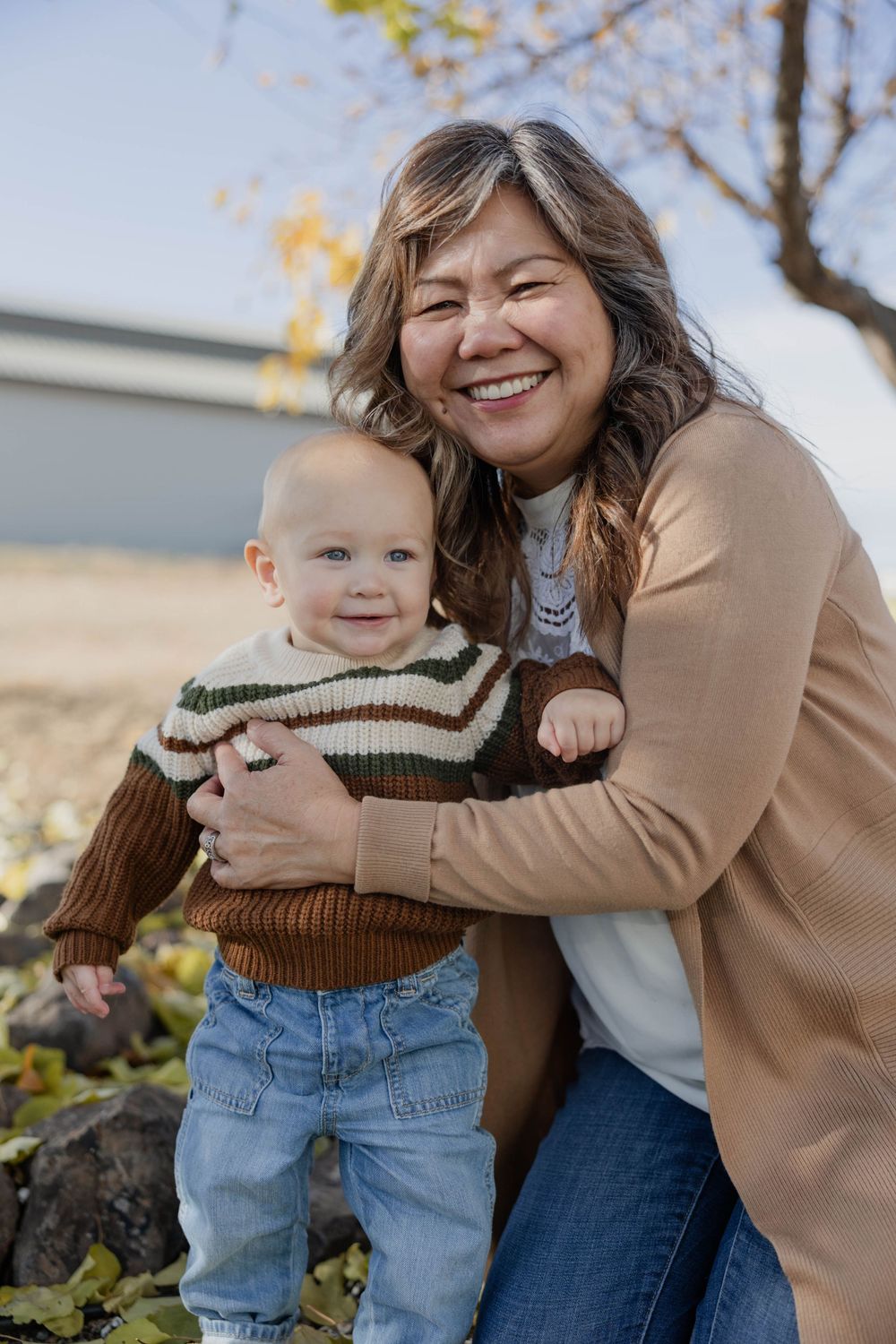 Playful outdoor moments captured during autumn family photoshoot.