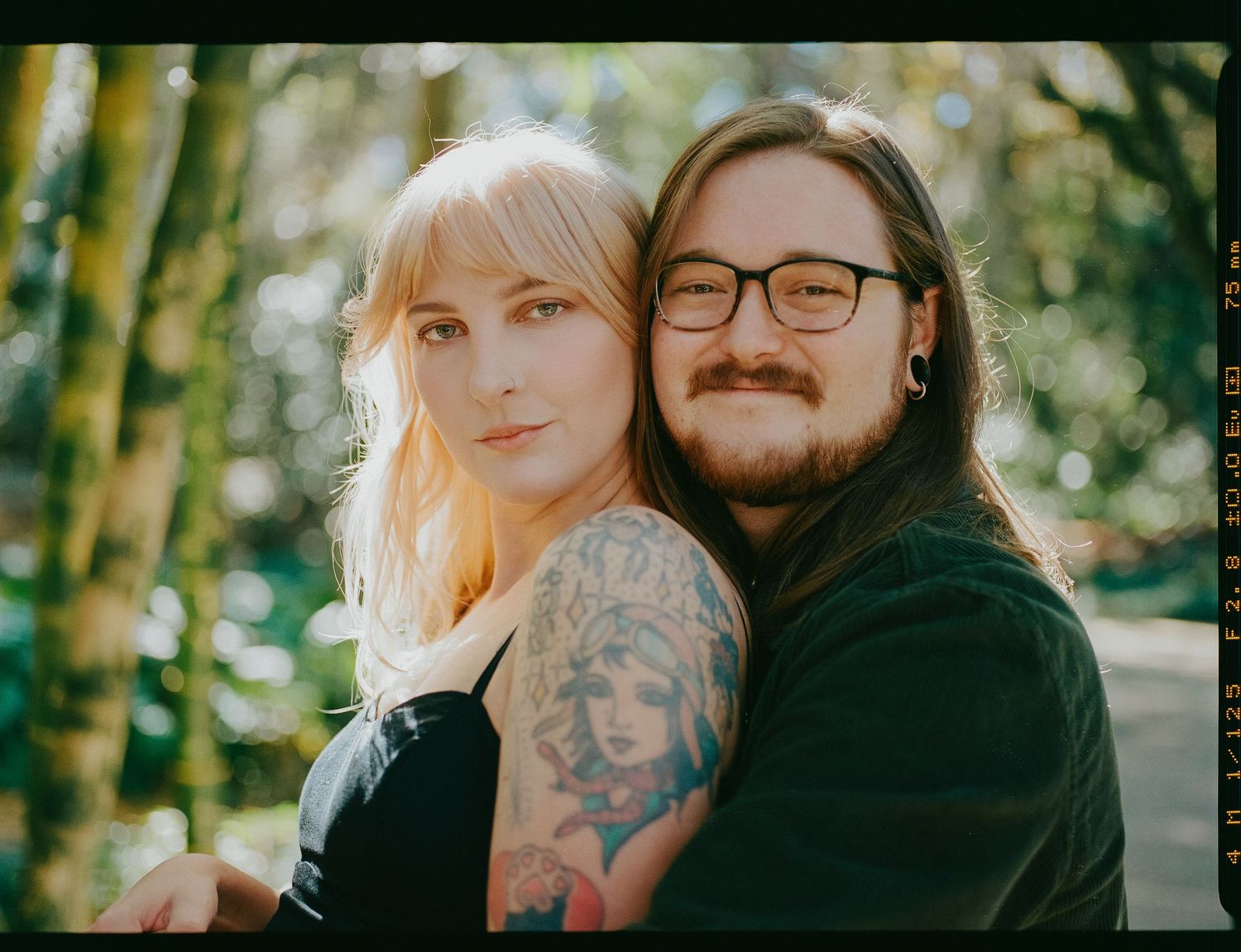A couple poses together outdoors in a series of romantic portraits at leu gardens