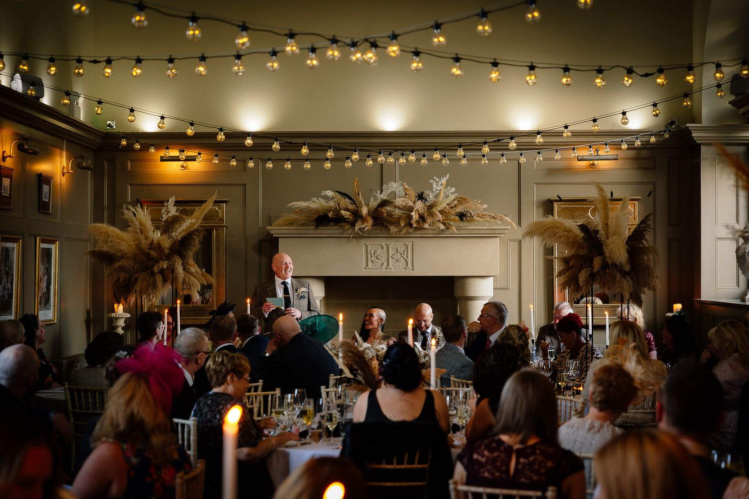 Wedding reception venue with twinkling string lights creating warm ambiance. Ellingham Hall