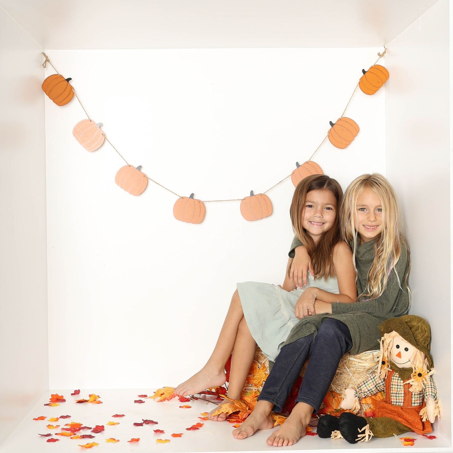 Autumn themed lifestyle photography with orange garland and fall decorations on white background. Box photography session