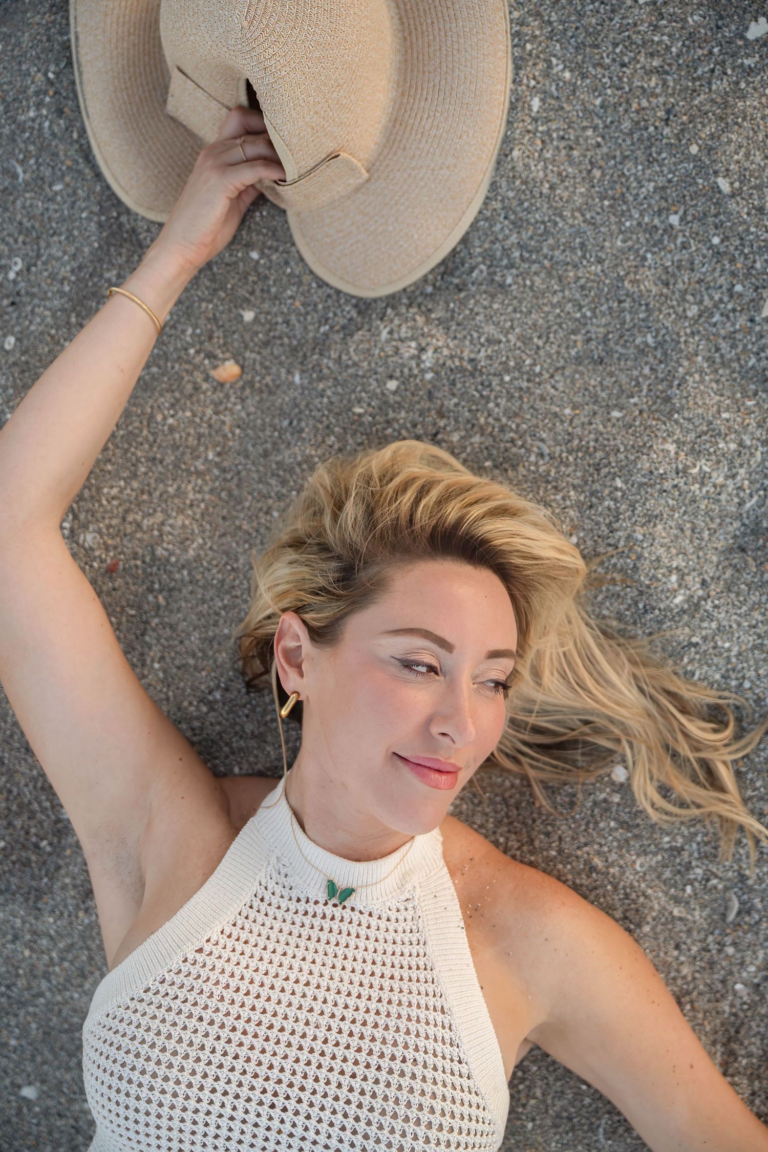 Client posing lying in the sand of Coral Cove beach, Tequesta, Florida