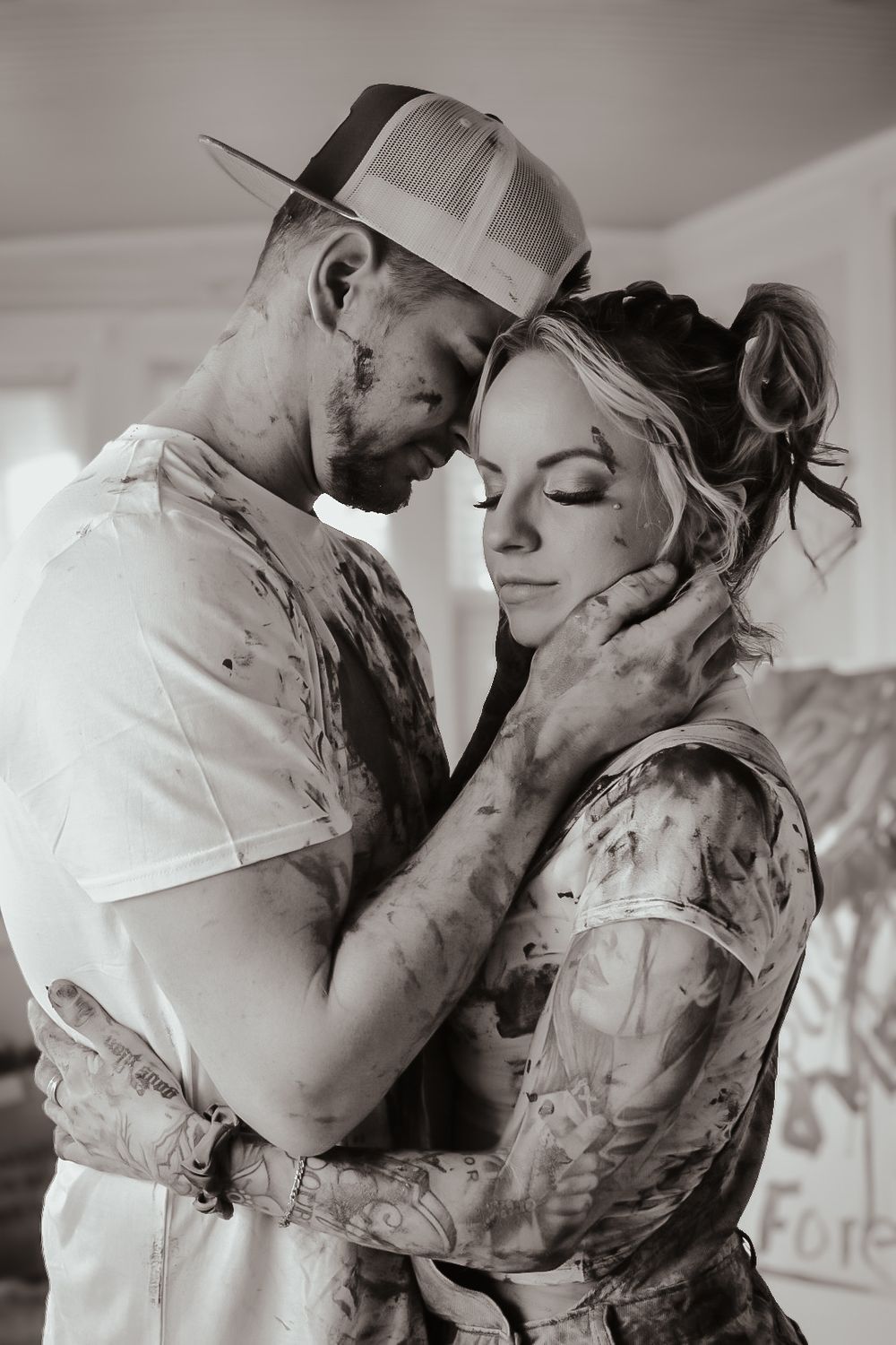 Black and white series showing tender moments between a couple in casual attire.