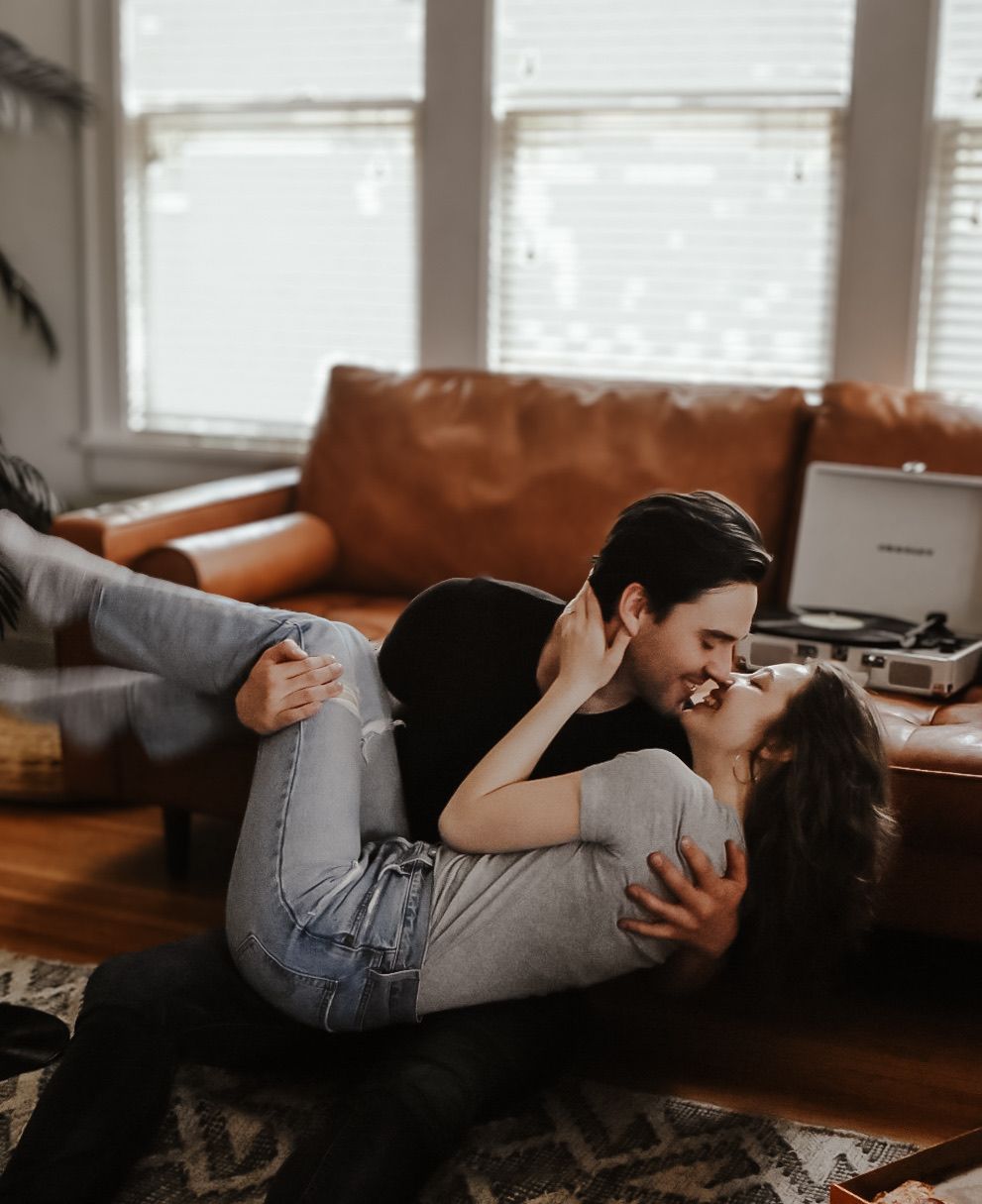 Candid moments of a couple lounging together on a brown leather couch.