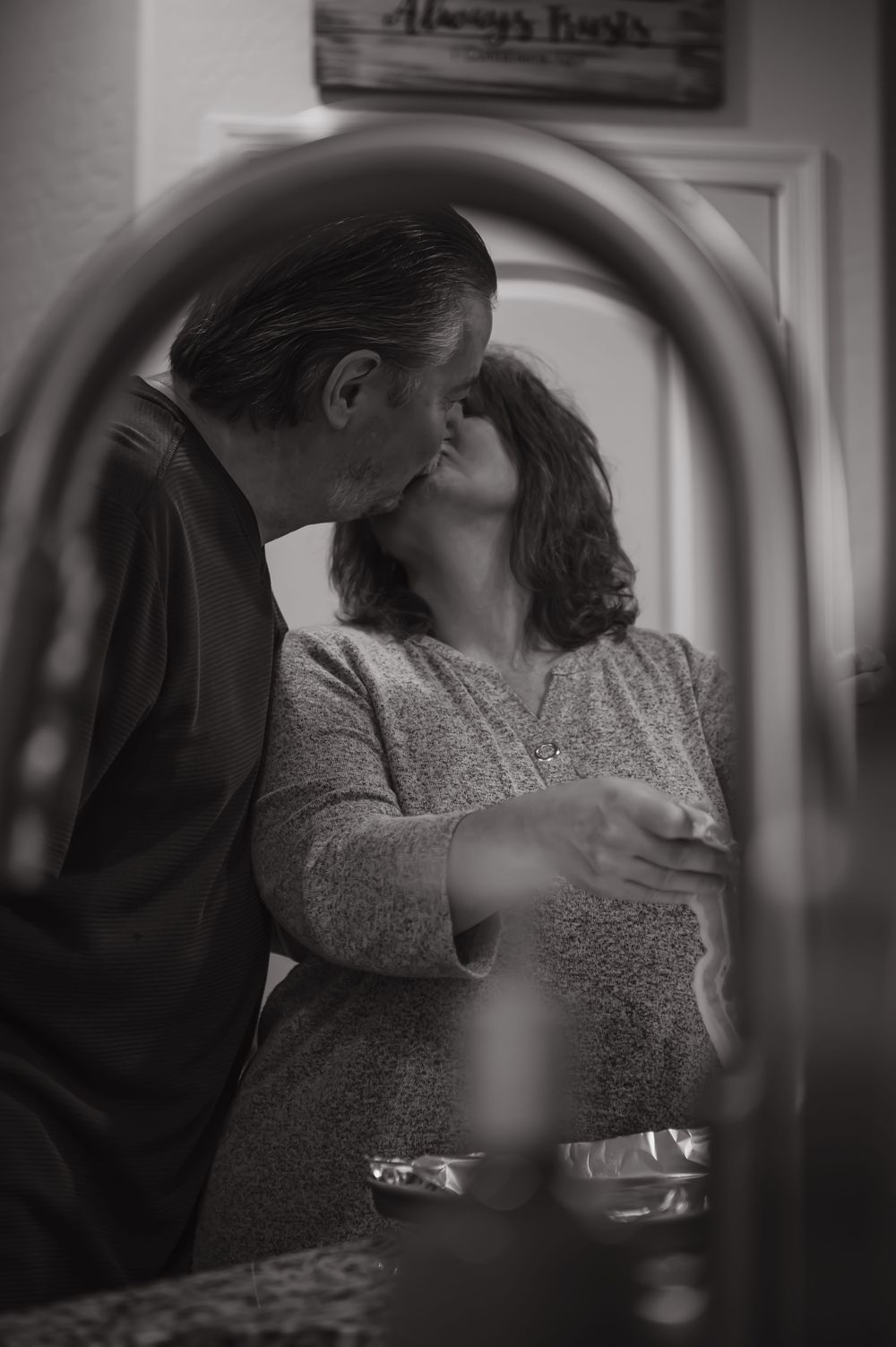 A romantic black and white portrait captured through a mirror frame.