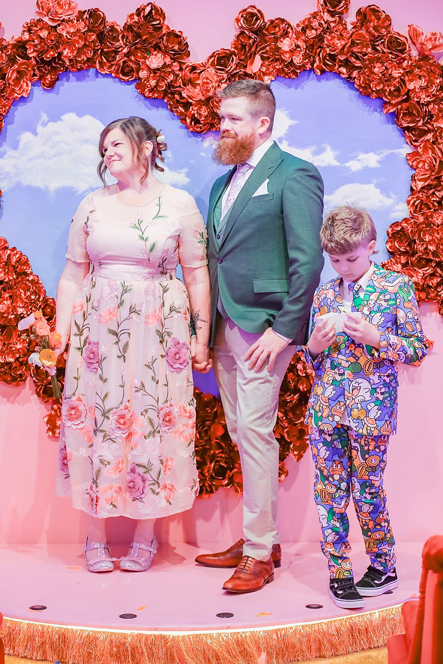 A series of casual portraits showing people in coordinated pink and floral outfits against a red floral backdrop.