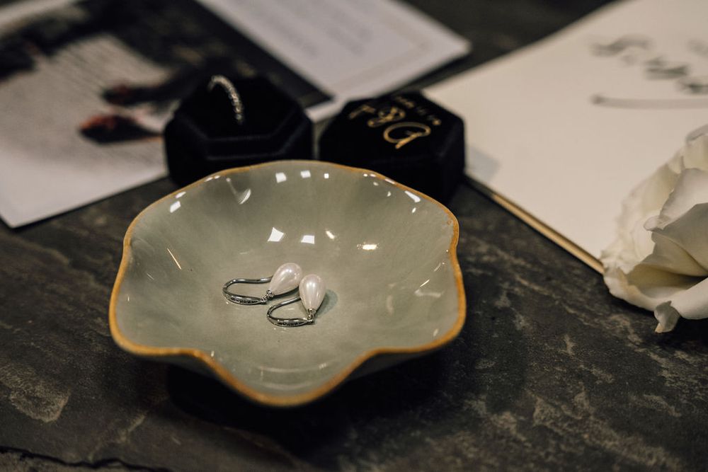 Elegant scalloped porcelain plates with gold trim on a dark surface.