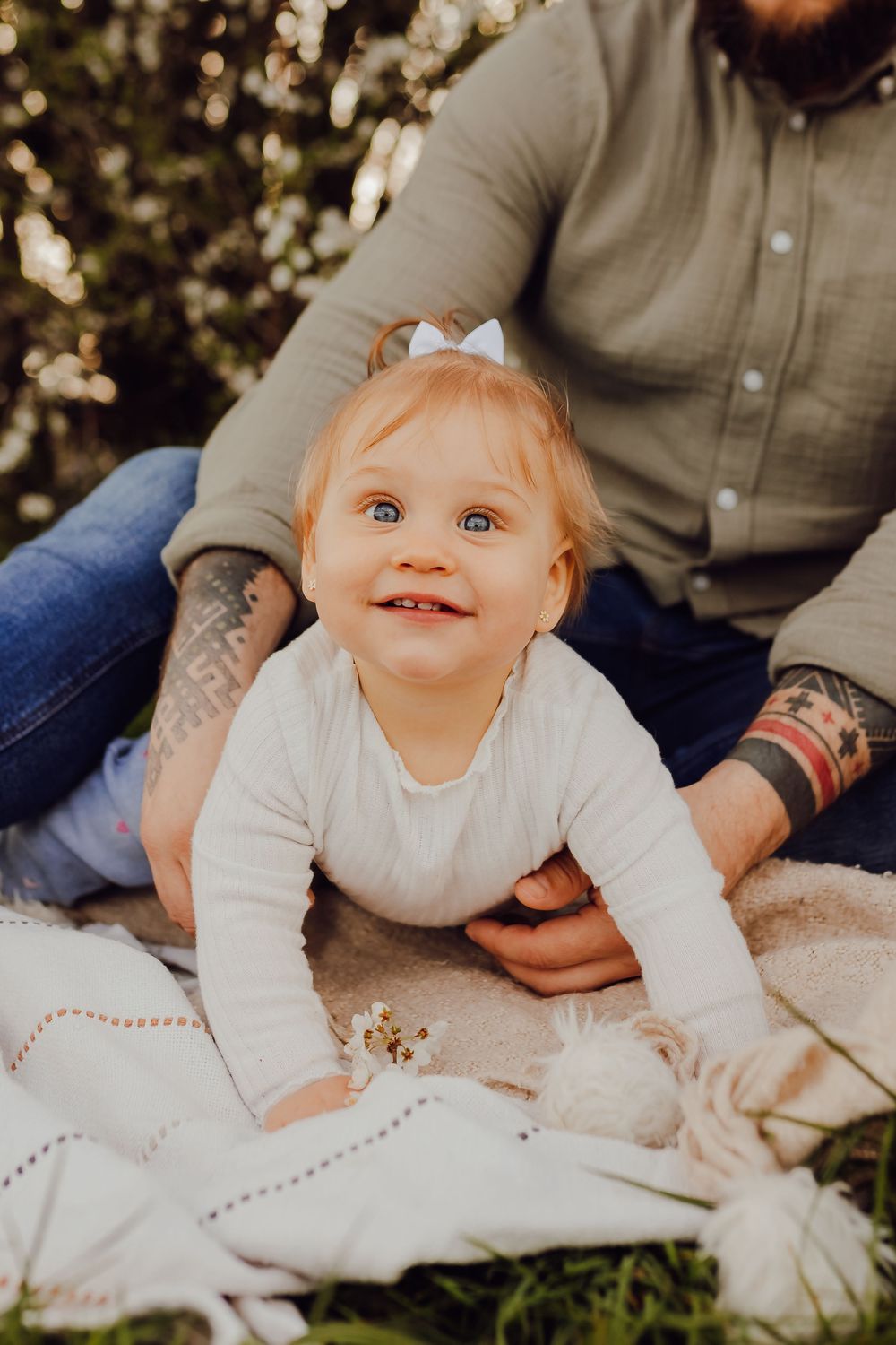 Candid family photo with spring blossom tree, light and airy family photography