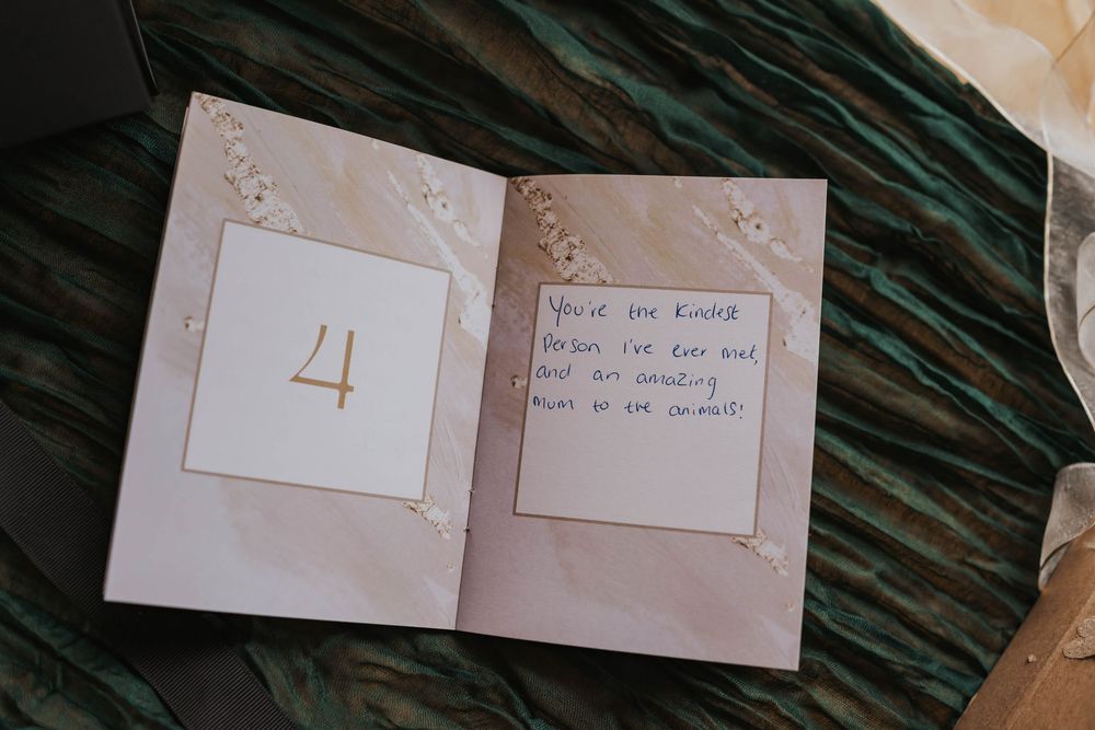 A series of white paper notes arranged in a row against a dark wooden surface.