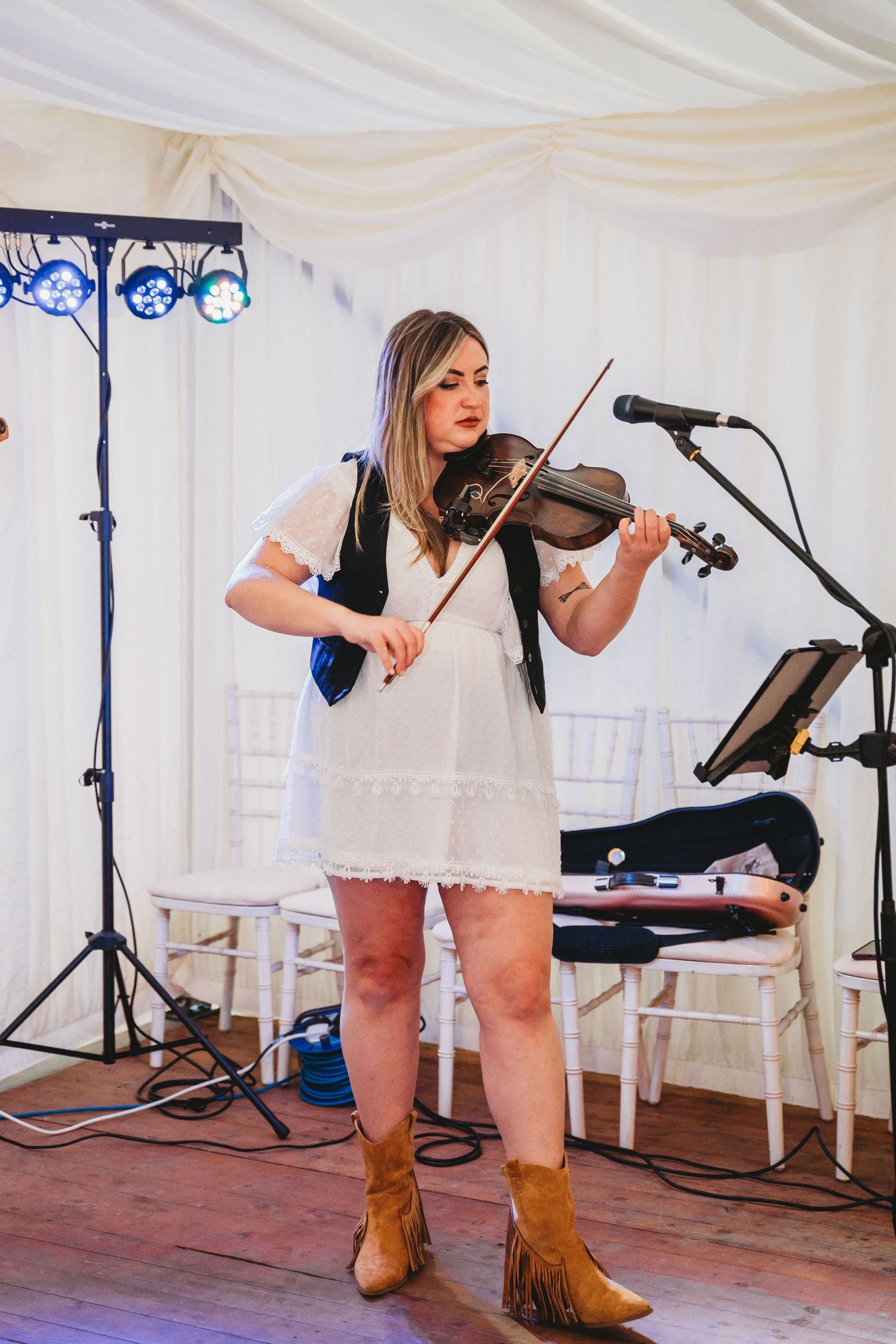 Photographers capturing moments during a wedding preparation session in a bright indoor setting.