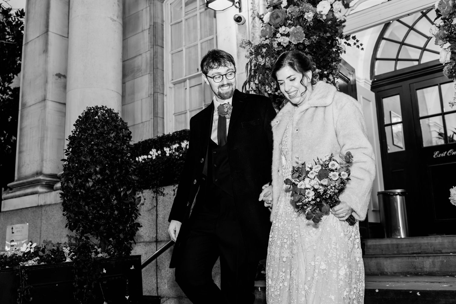 A series of black and white wedding photos showing couples posing in formal attire at elegant venues.