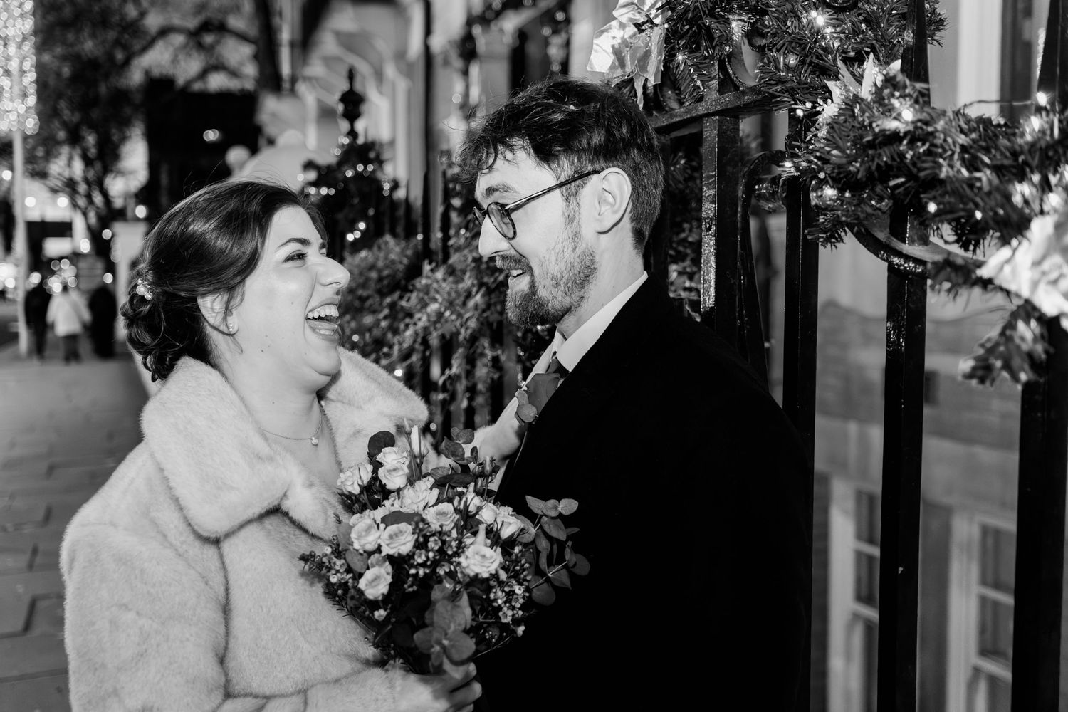 A couple shares a romantic moment during their wedding celebration outdoors.