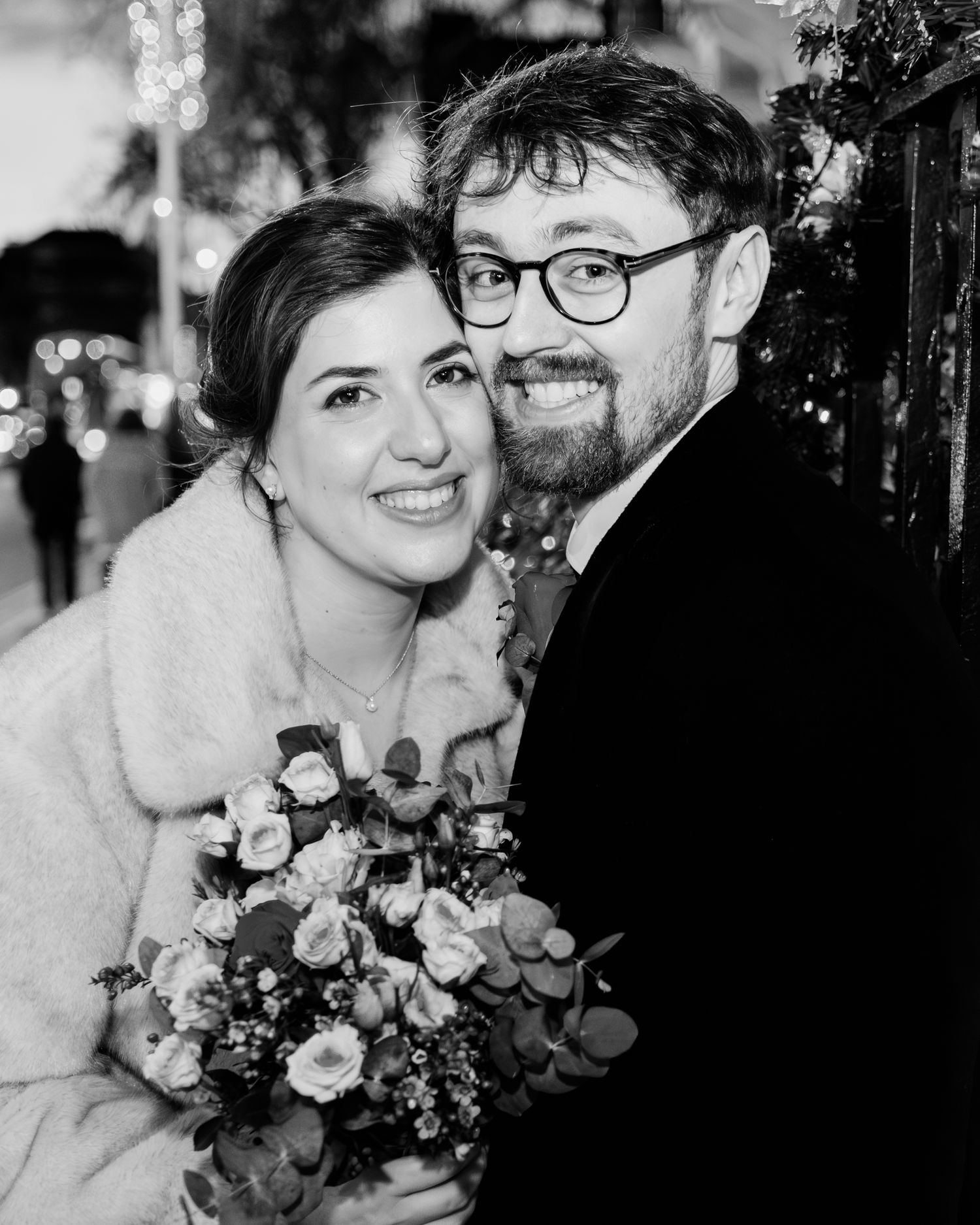 A black and white wedding photo series showing a couple sharing intimate moments with a beautiful floral bouquet.