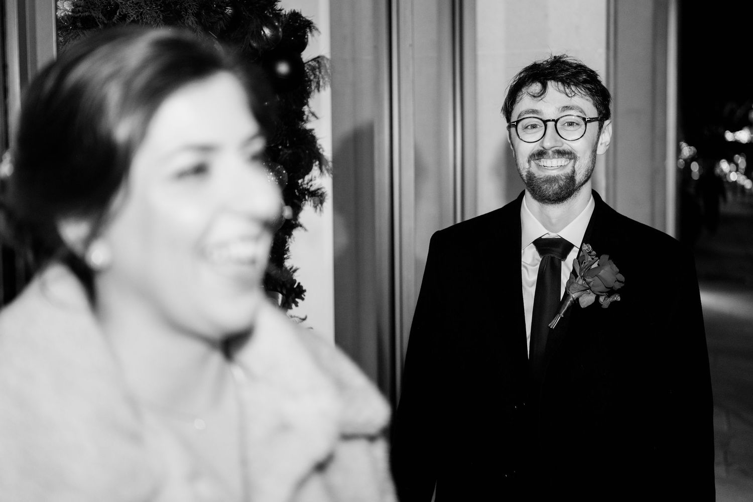 A black and white photo collage showing candid moments at what appears to be a wedding celebration.