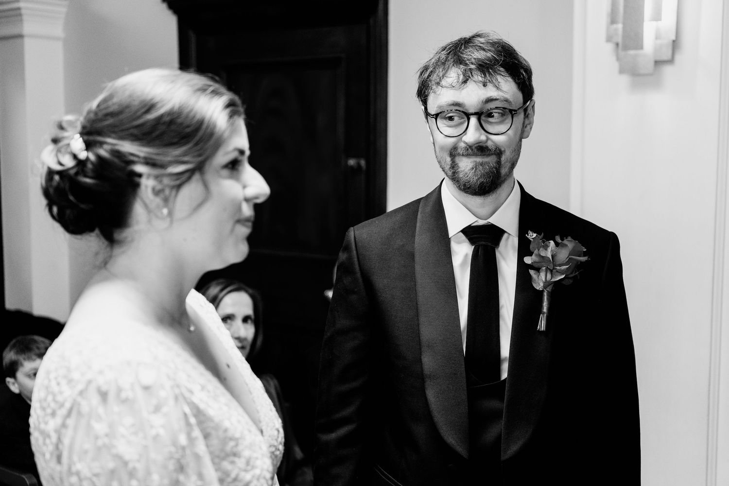 Black and white wedding photos show intimate moments between a couple in formal attire.