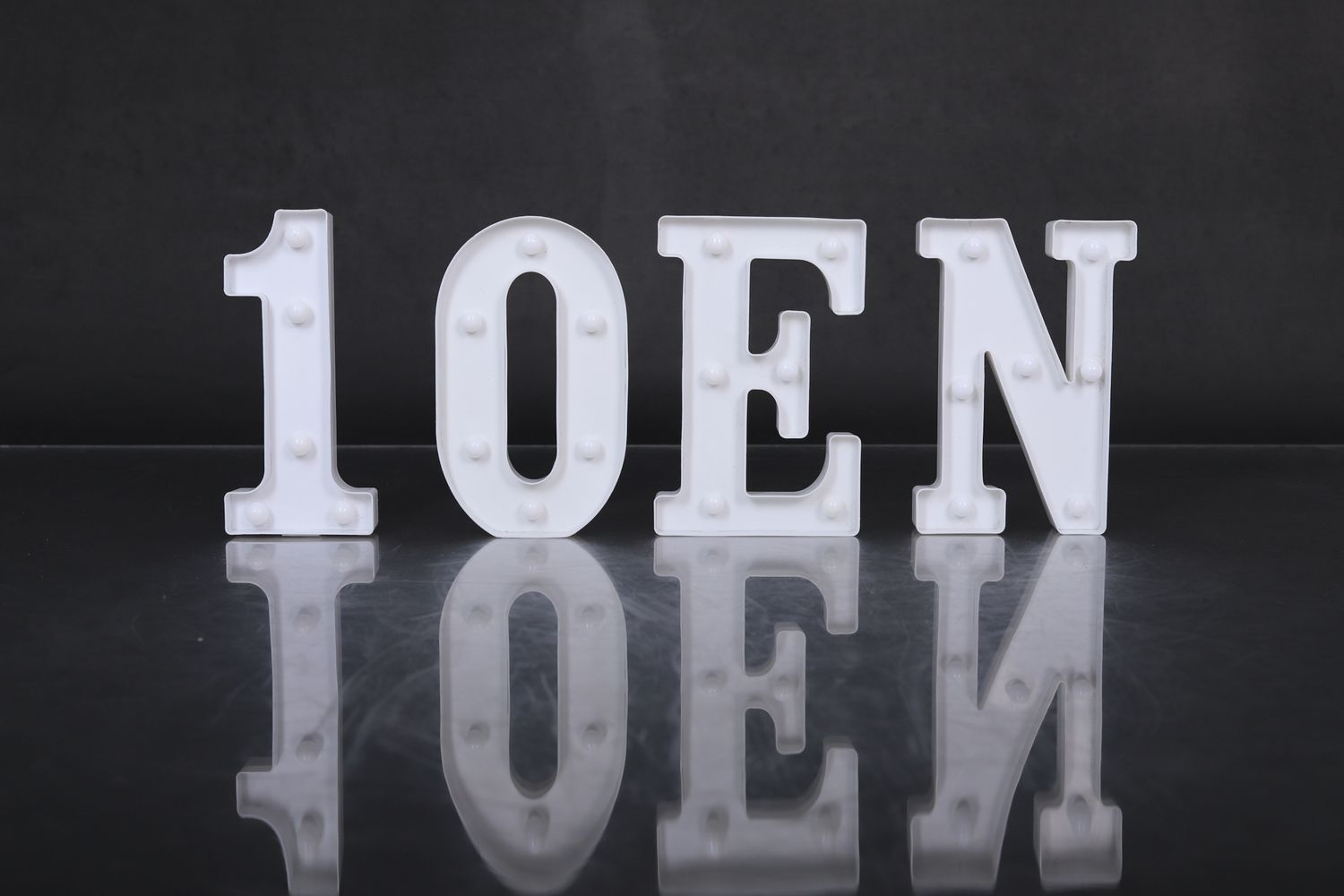 A series of white letters spelling 'TOEN' appear in a repeating pattern against a dark background.