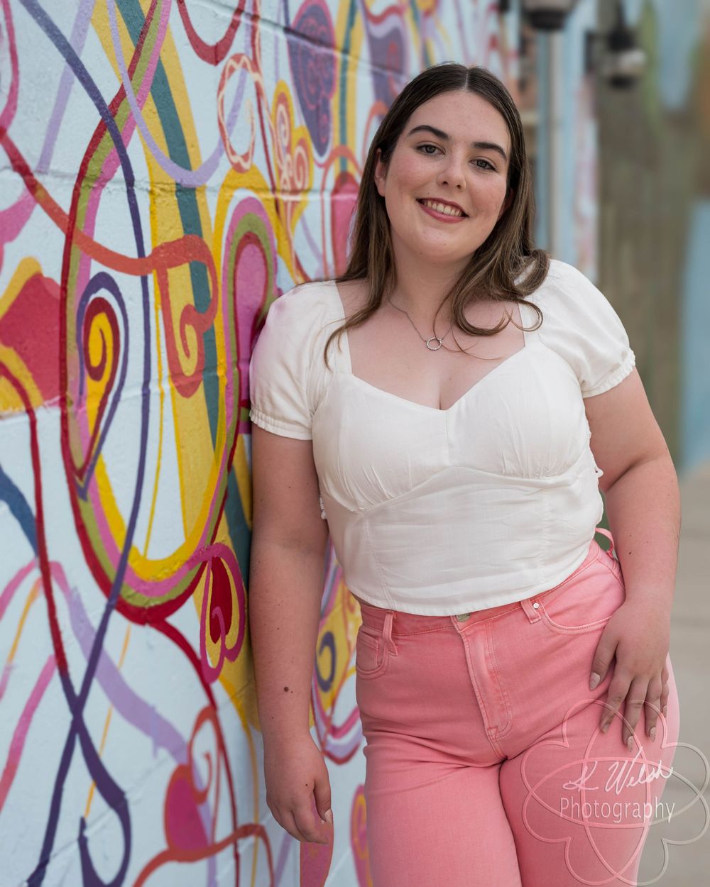 Senior portrait by mural
