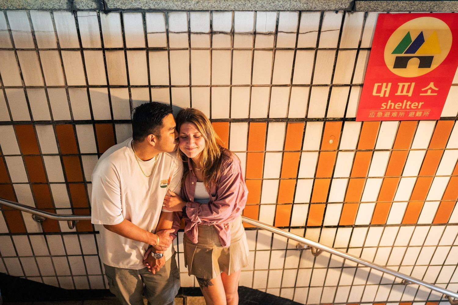 A series of five similar photos showing a couple sitting together on steps with orange and white striped walls.