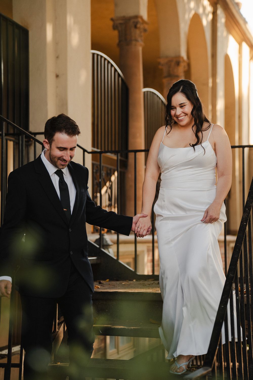 Bride and groom walking together during their Pasadena wedding captured in warm natural light