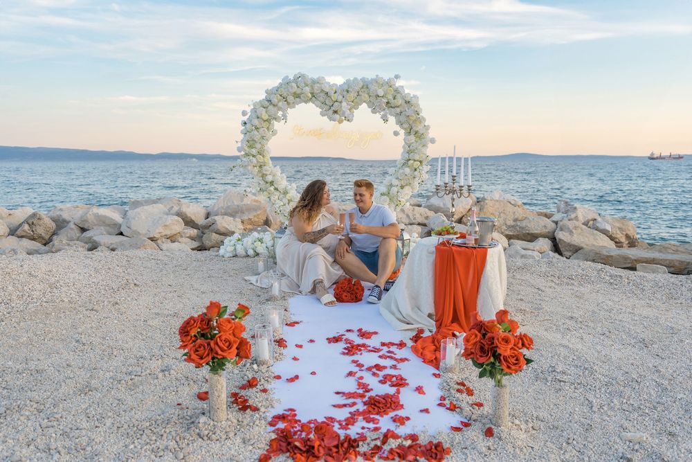 Split Beach Proposal flower heart arch with picnic and photosession
