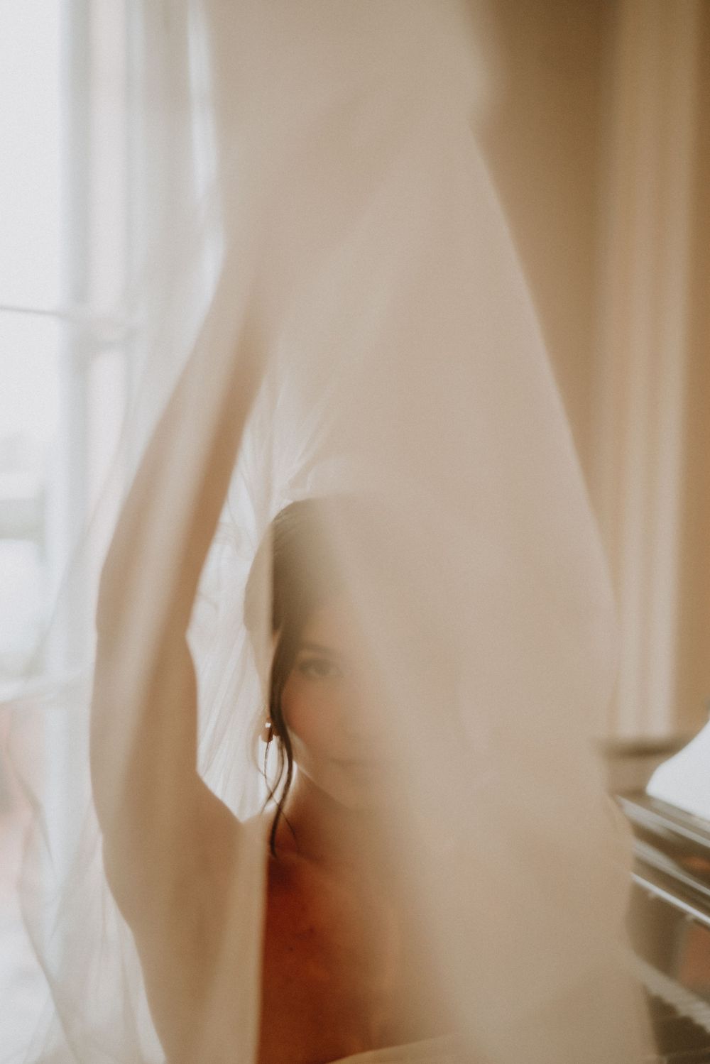 Abstract close-up of flowing white fabric with soft focus and gentle lighting.