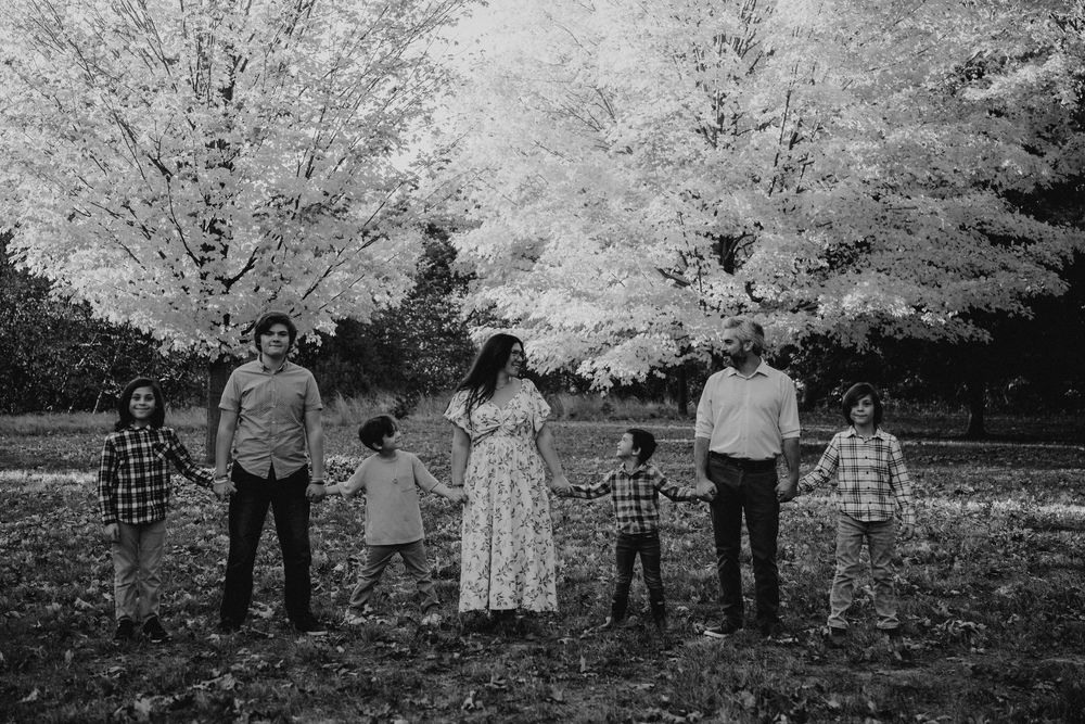 A collection of vintage black and white photographs showing people gathered under blooming cherry trees in a garden setting.