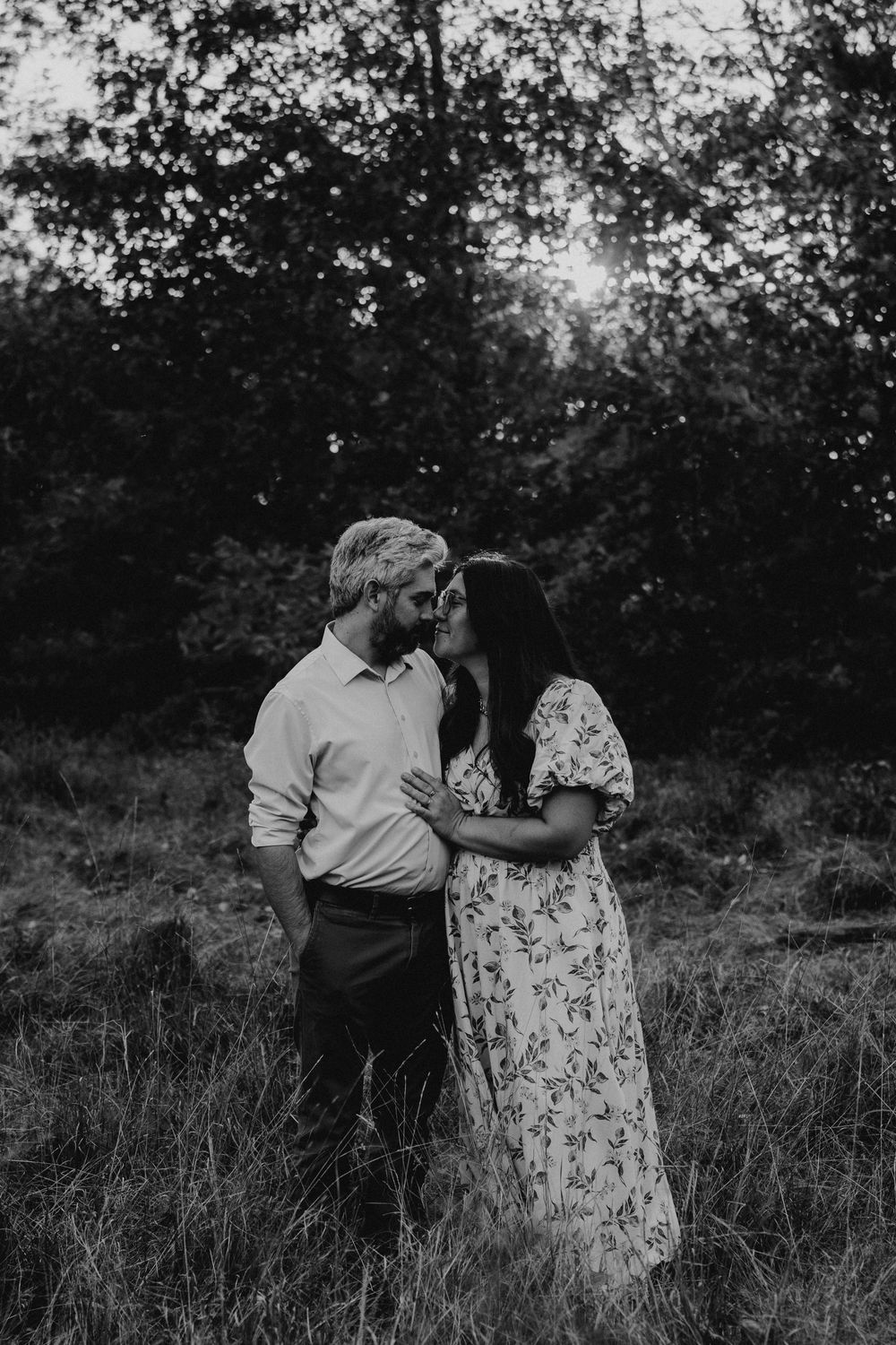 A black and white photo sequence showing a romantic moment between two people standing in tall grass.