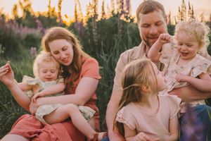 Family photos in a lupine wildflower field during their spring photography session near Seattle, Washington