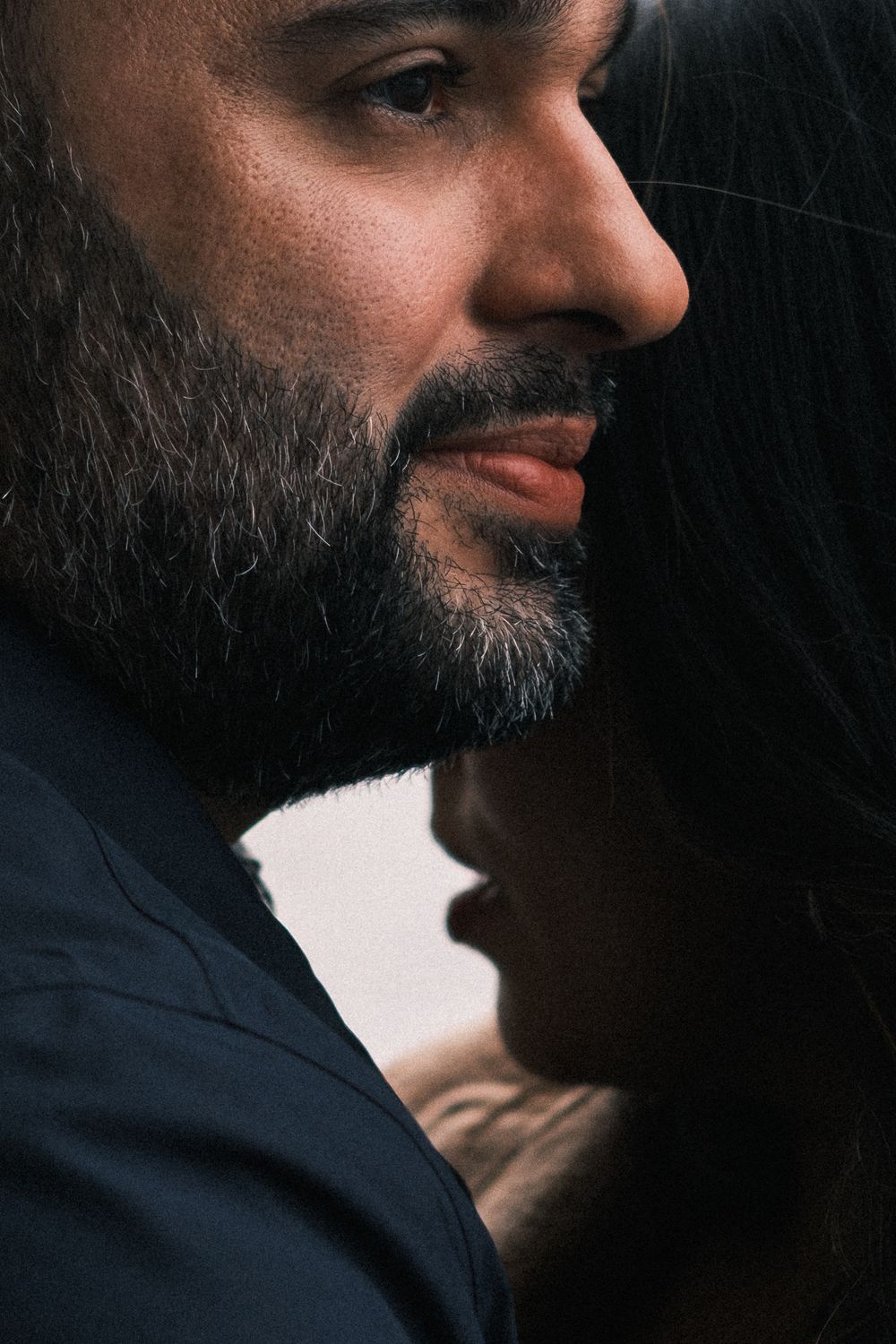 Dramatic side profile portrait with contrasting light and shadow.