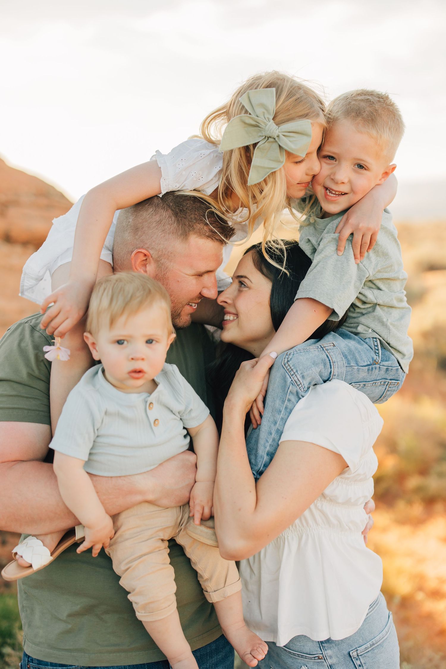 Family enjoying autumn scenery during golden hour photo shoot in mountain forest.