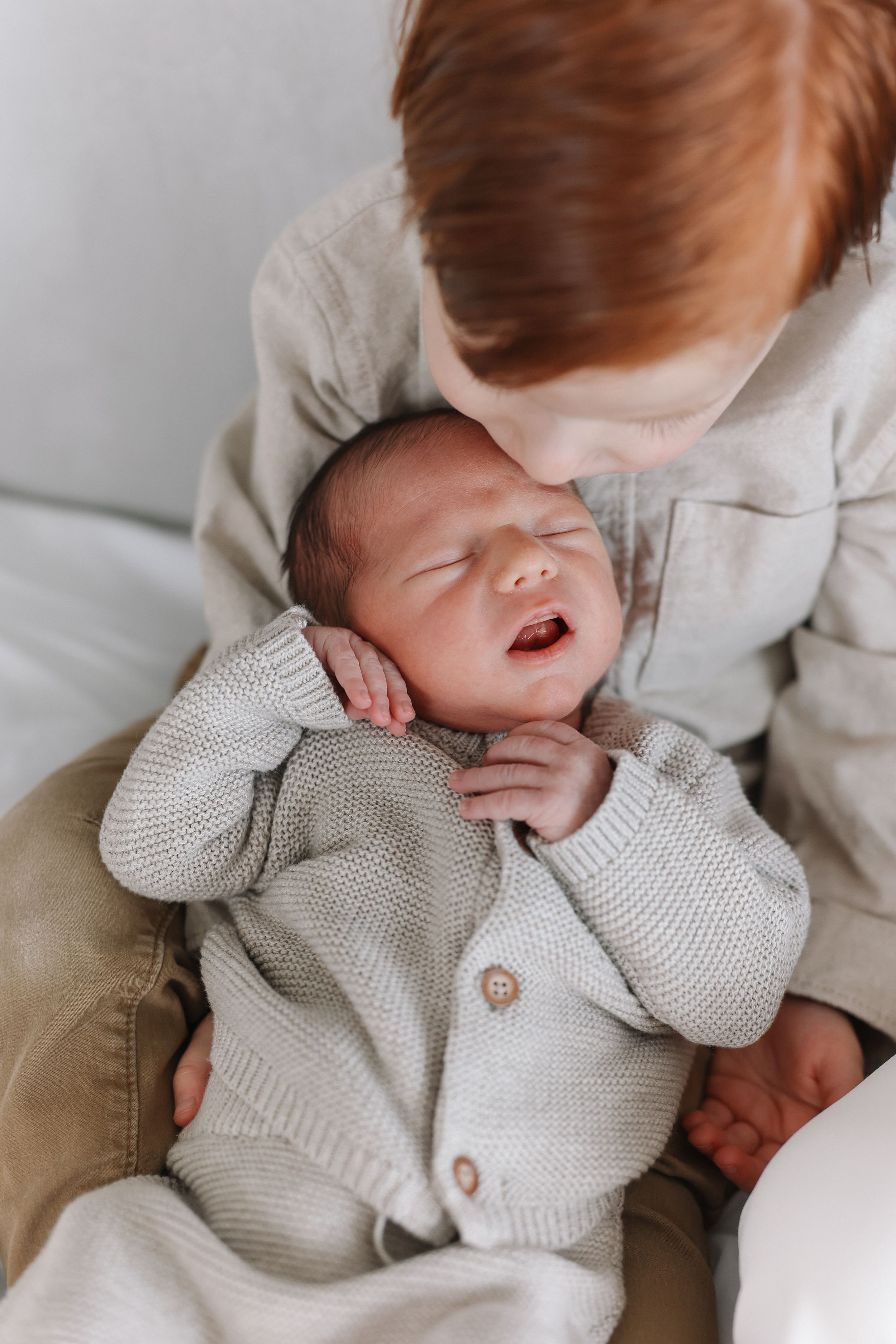 Close newborn detail shot of baby and his big brother photographed in Orange County