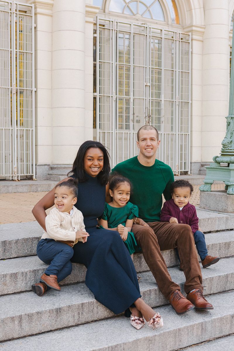 Parents sitting on steps with children in editorial-style Prospect Park family photography
