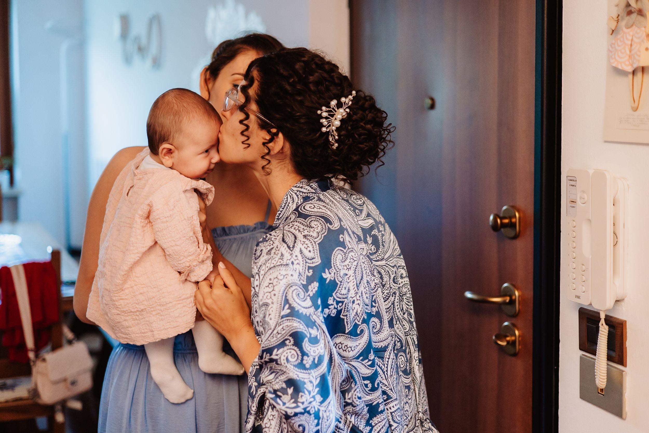 A tender family moment captured indoors with soft lighting and warm tones.