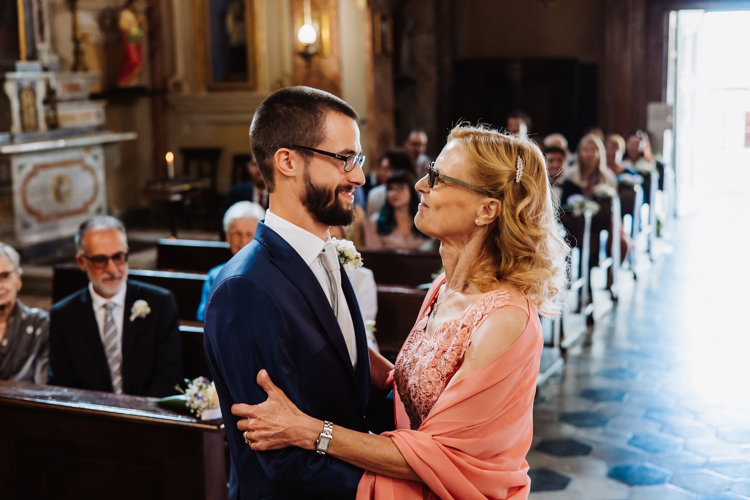 Couple dancing together at an elegant venue with warm lighting and ornate architectural details.