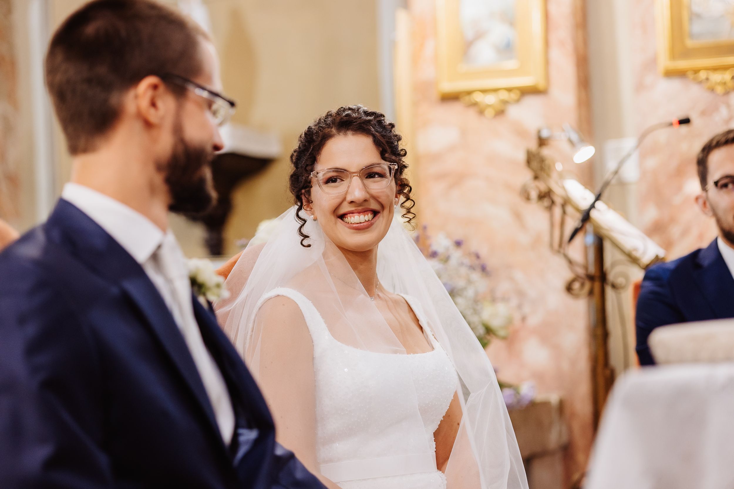 A joyful moment captured during a wedding ceremony in an ornate church interior.