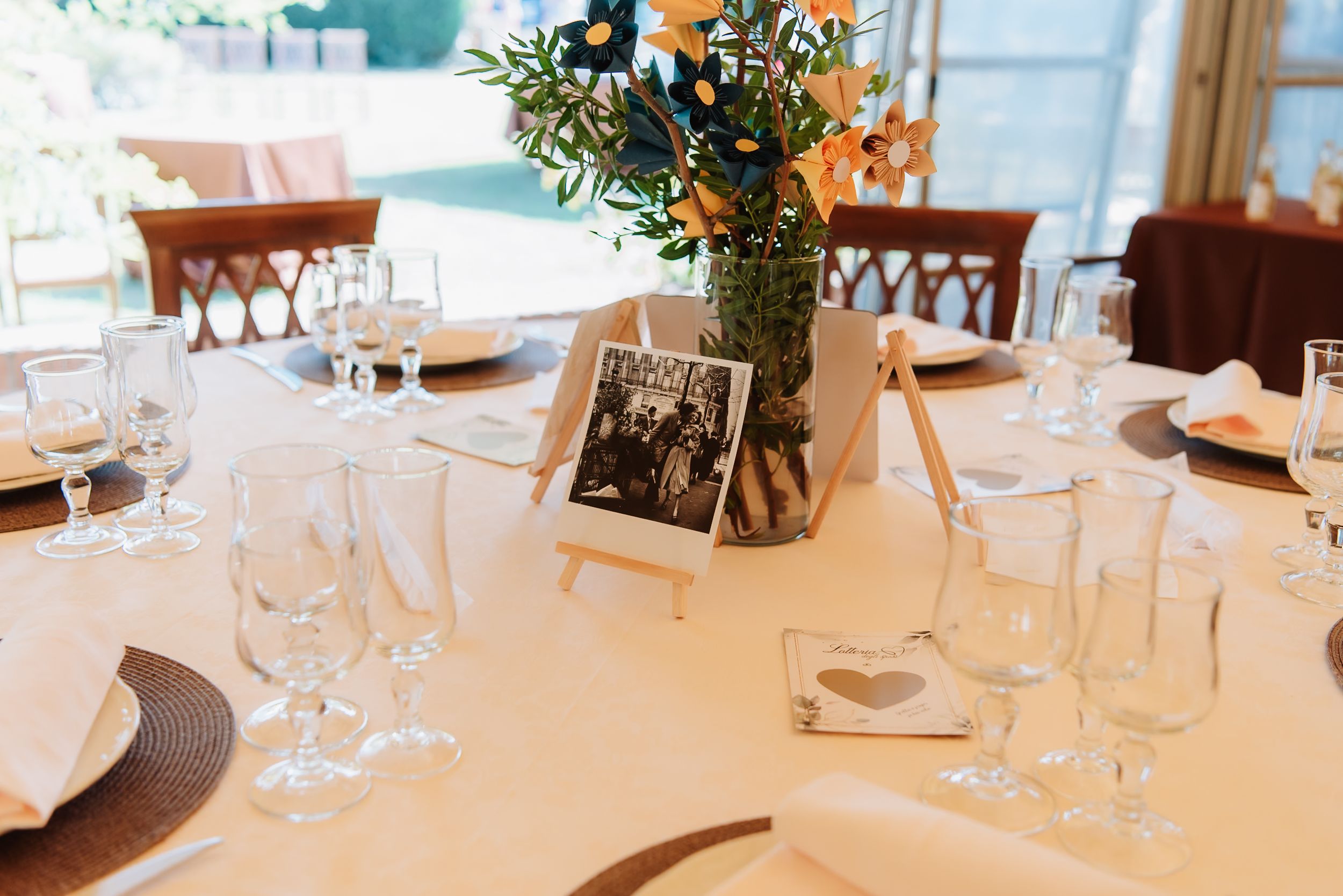 Elegant table settings with white linens and wine glasses in an upscale restaurant dining room.