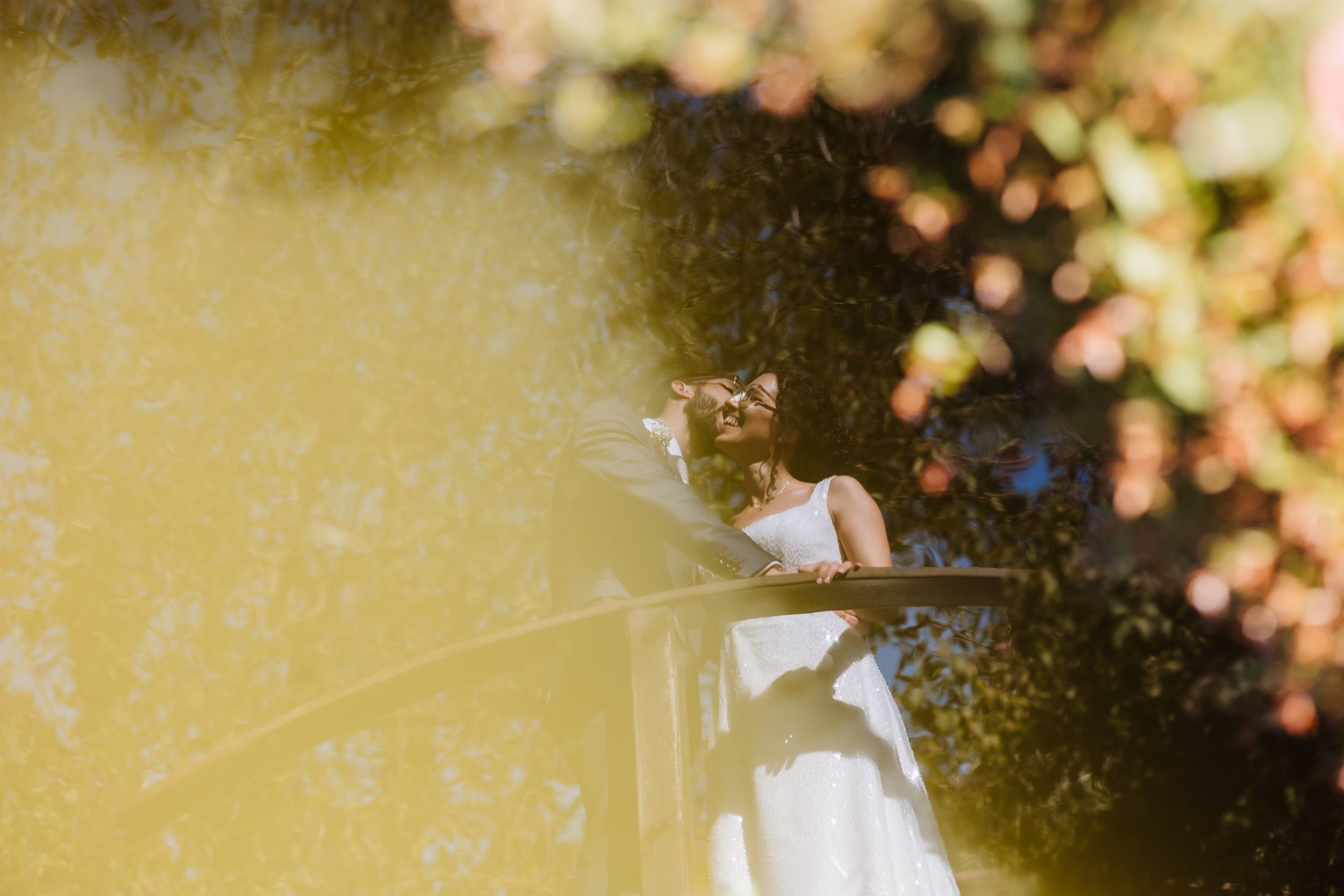 Dreamy sunlit portrait through car window with soft bokeh and warm golden light.
