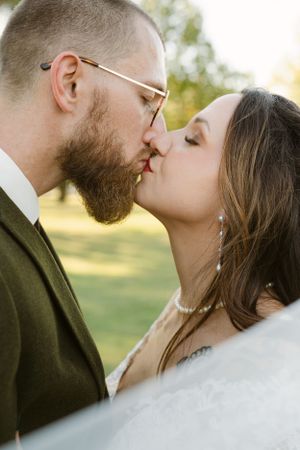 Romantic close-up of a couple sharing a tender moment at their wedding.