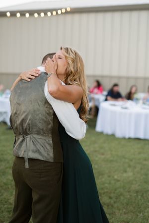 A couple shares a dramatic dip dance move at their wedding reception.